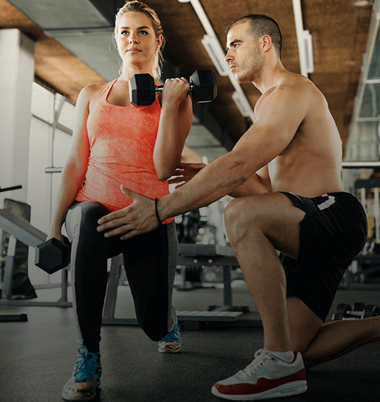 A client working with a personal trainer to achieve their specific fitness goals.