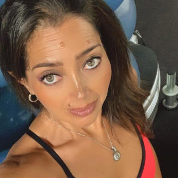 Trainer providing personalized fitness instruction.